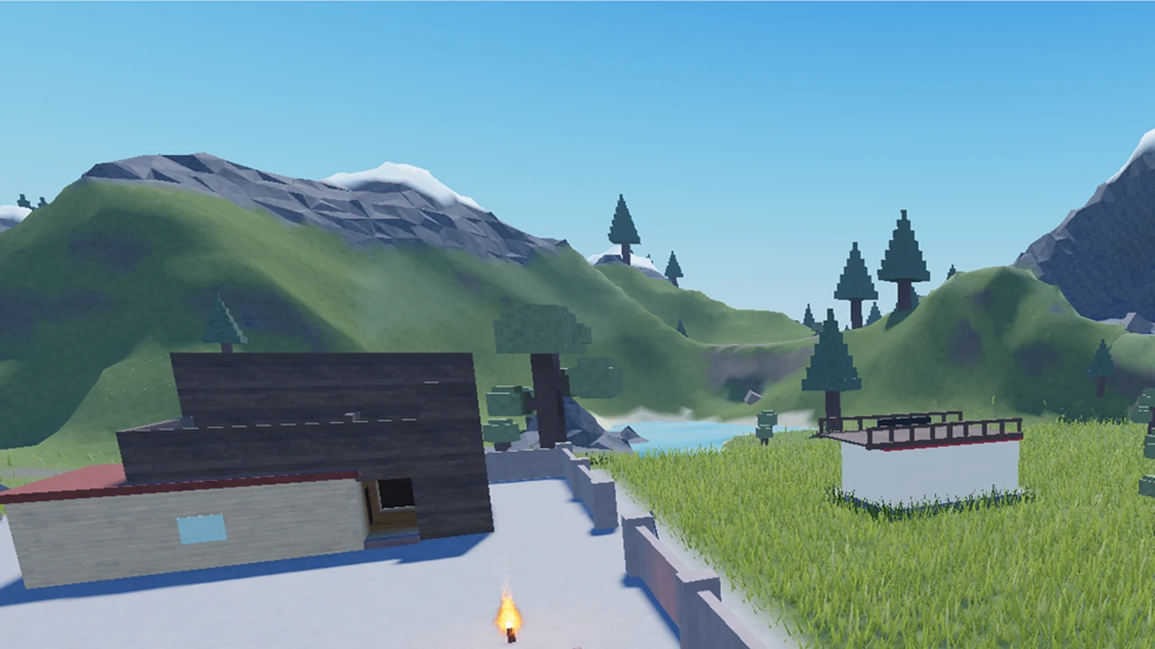 Town buildings on a concrete pad with hills, trees, and a lake in the distance
